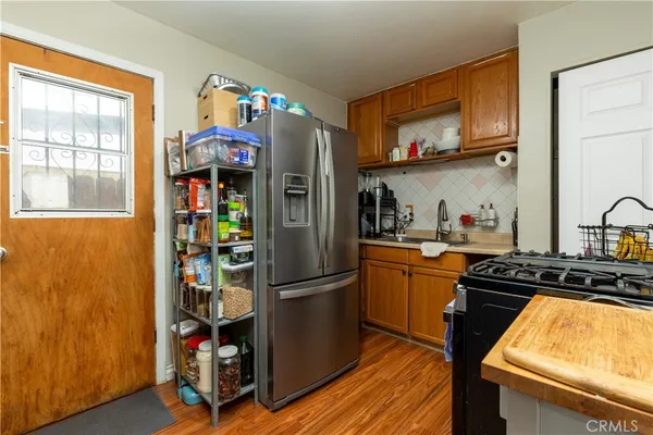 a kitchen with stainless steel appliances granite countertop a refrigerator and a stove top oven