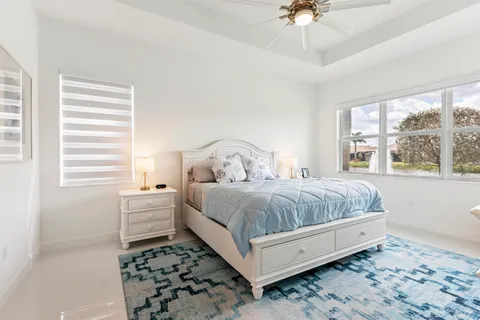 a bedroom with a large bed and a flat screen tv