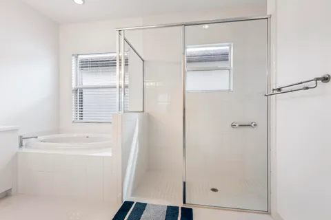 a large white kitchen with a sink and cabinets