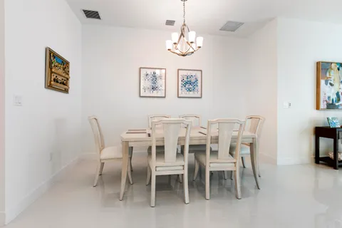 a dining room with furniture and chandelier