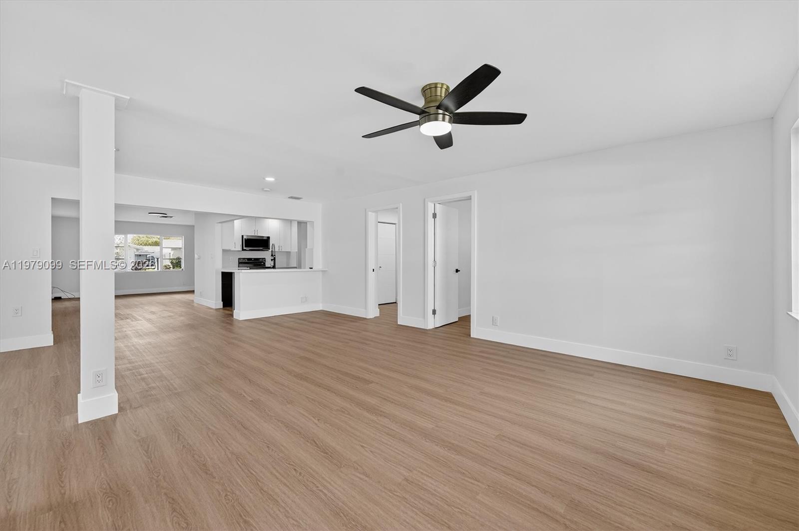 8941 Northwest 13th Street Plantation, FL 33322 - Photo 11 of 26 a view of empty room with wooden floor and window