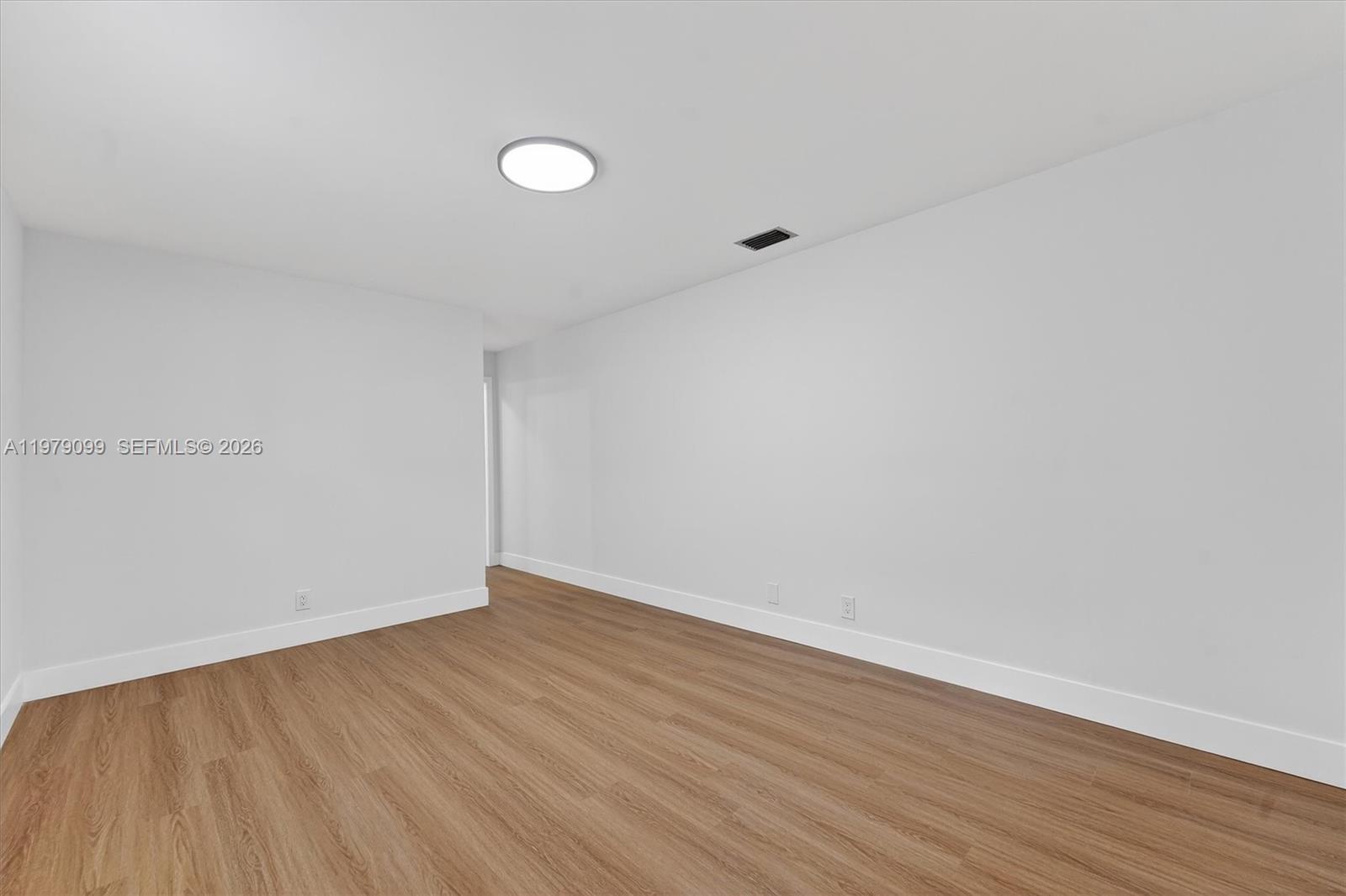 8941 Northwest 13th Street Plantation, FL 33322 - Photo 13 of 26 a view of an empty room with wooden floor and fan