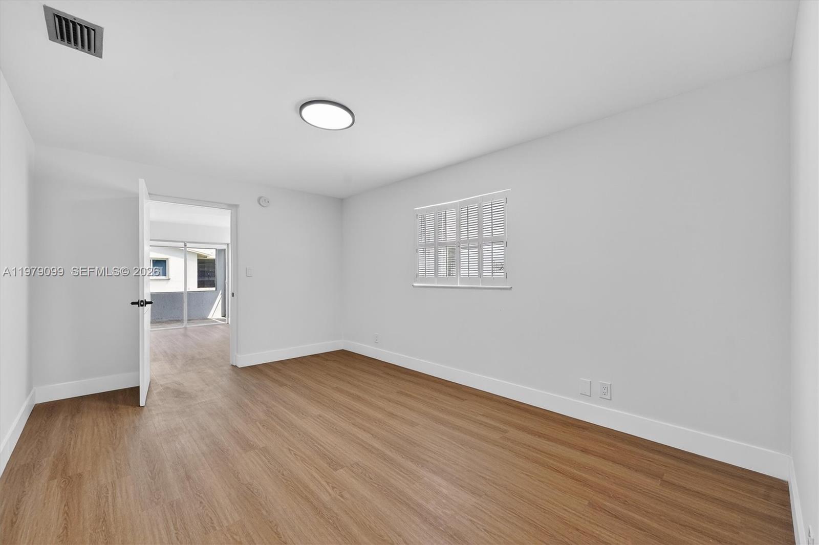 8941 Northwest 13th Street Plantation, FL 33322 - Photo 14 of 26 an empty room with wooden floor and windows