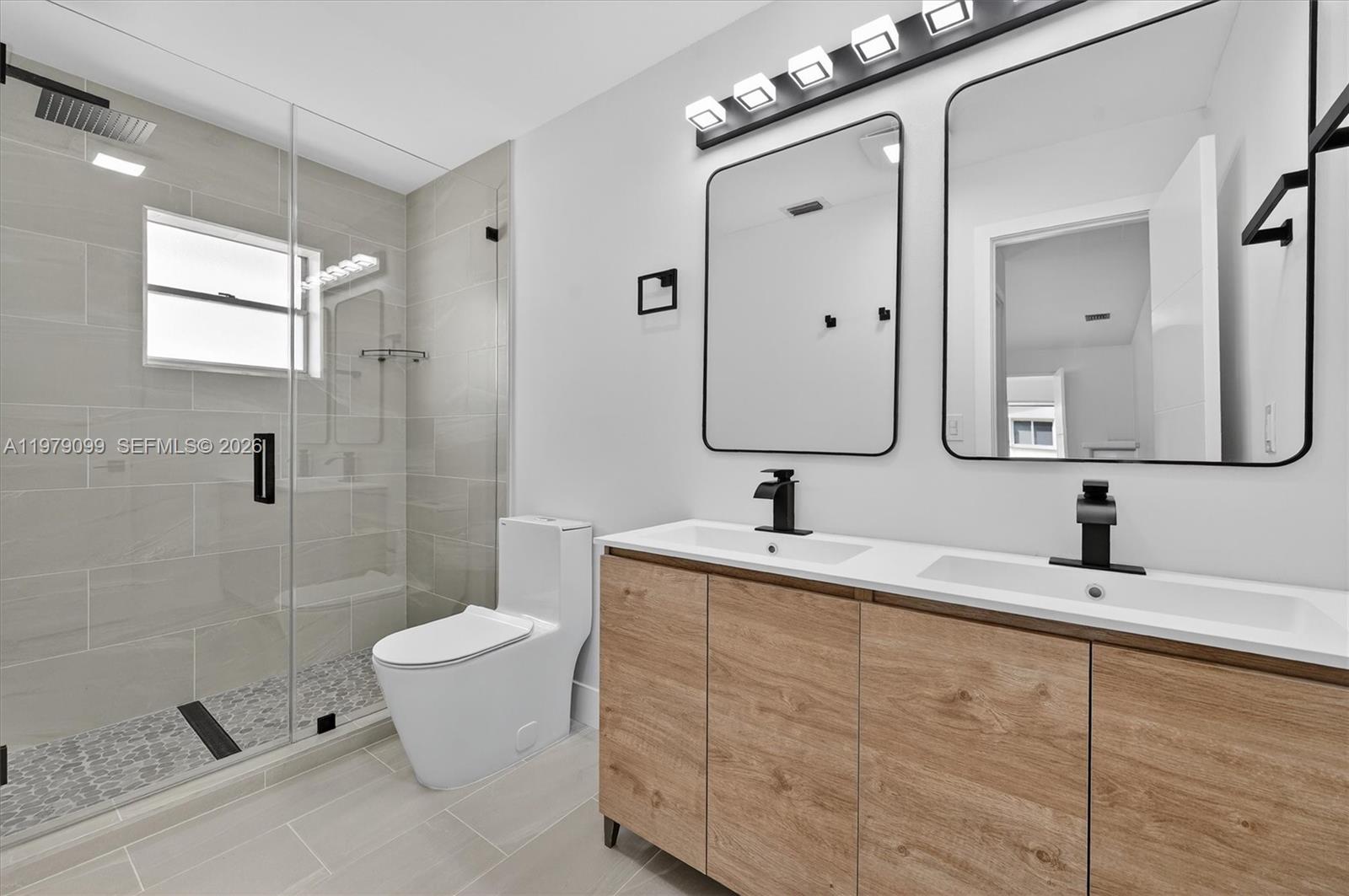 8941 Northwest 13th Street Plantation, FL 33322 - Photo 15 of 26 a bathroom with a toilet sink and mirror
