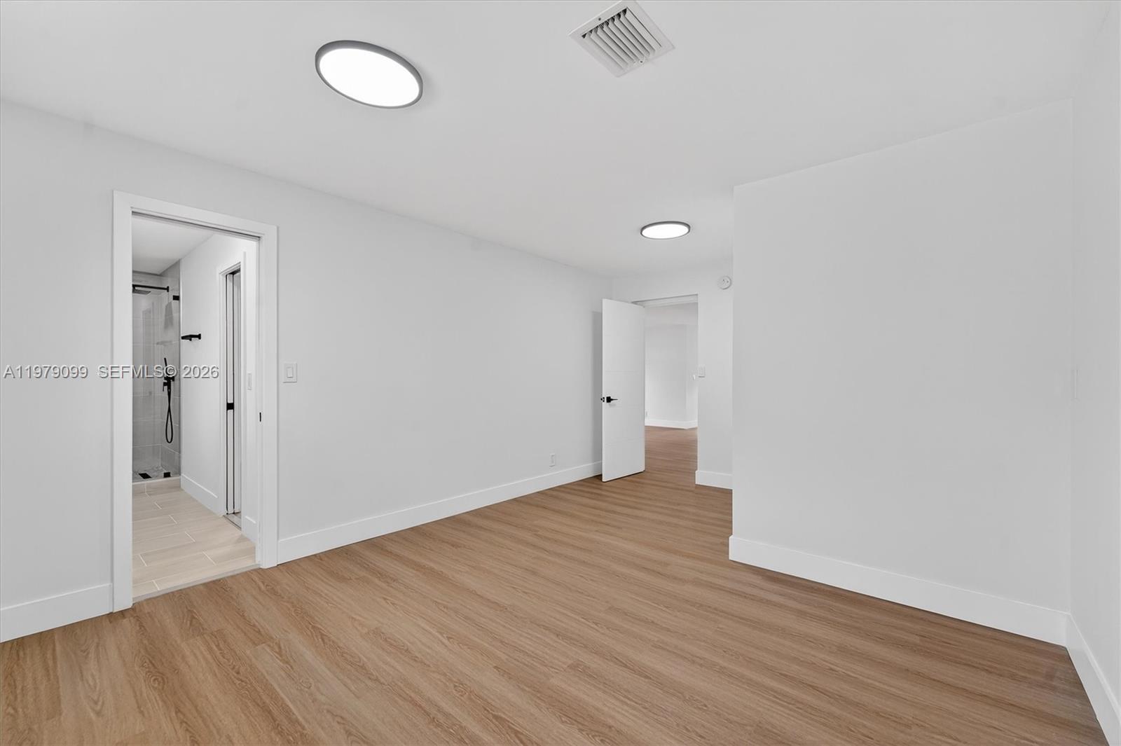 8941 Northwest 13th Street Plantation, FL 33322 - Photo 18 of 26 a view of an empty room with wooden floor