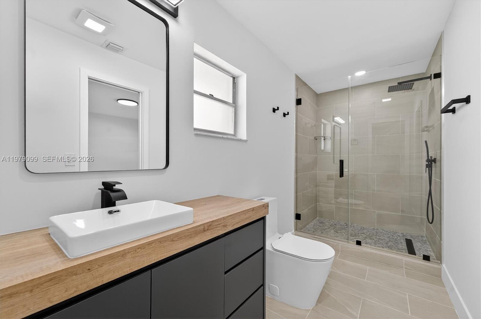 8941 Northwest 13th Street Plantation, FL 33322 - Photo 19 of 26 a bathroom with a sink a toilet and shower