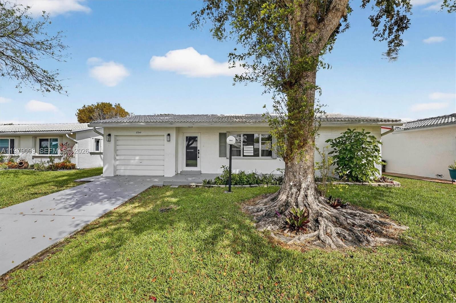8941 Northwest 13th Street Plantation, FL 33322 - Photo 2 of 26 a view of a house with a yard and plants