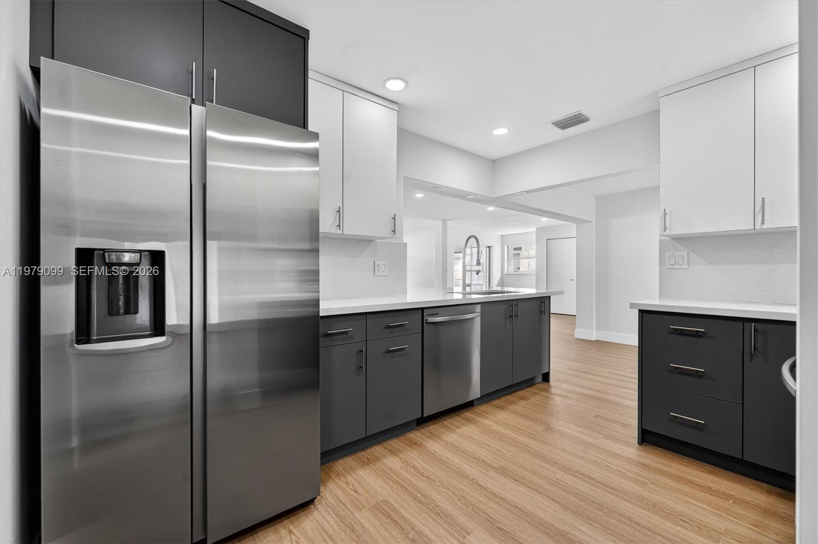 8941 Northwest 13th Street Plantation, FL 33322 - Photo 4 of 26 a kitchen with kitchen island a counter top space cabinets and stainless steel appliances