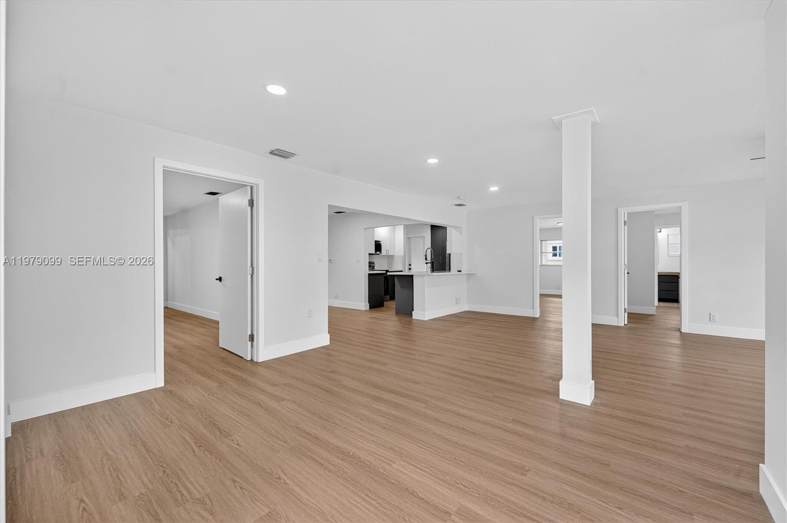 8941 Northwest 13th Street Plantation, FL 33322 - Photo 9 of 26 a view of a big room with wooden floor and a kitchen