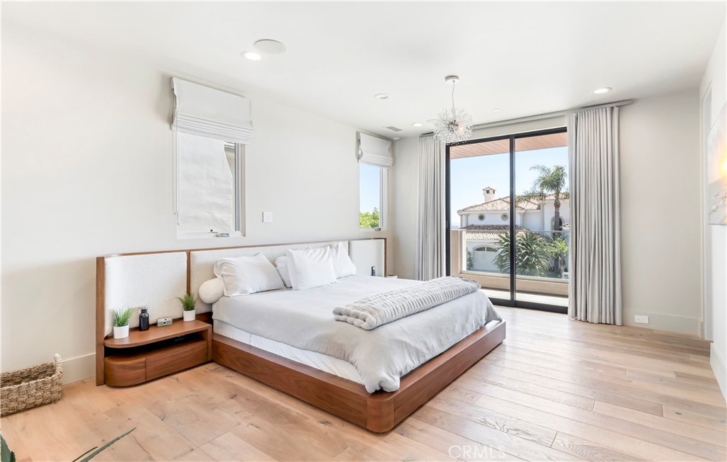 660 Kings Road Newport Beach, CA 92663 - Photo 26 of 41 a large bedroom with a bed and wooden floor