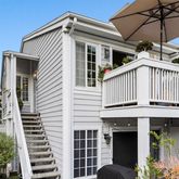 a view of a house with roof and plants