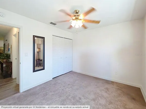 a view of a livingroom with furniture and a ceiling fan