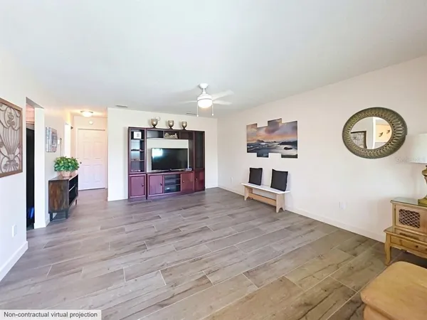 a view of a livingroom with furniture and a ceiling fan