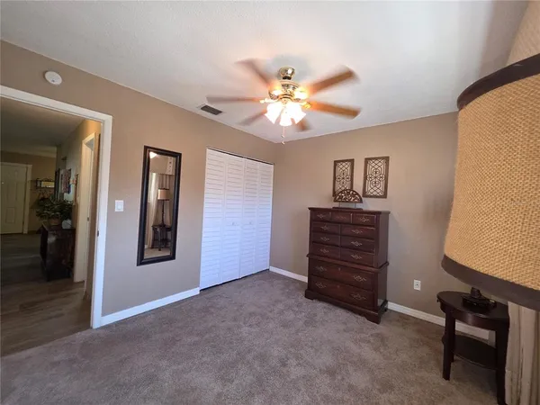 a view of a hallway to a livingroom with furniture and wooden floor