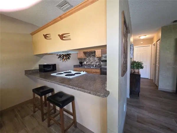 a kitchen with a refrigerator and a stove