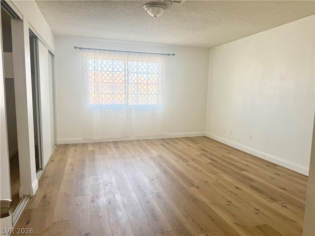 135 Primero Way Henderson, NV 89074 - Photo 12 of 15 The bright bedroom offers laminate flooring and ample storage with sliding closet doors.