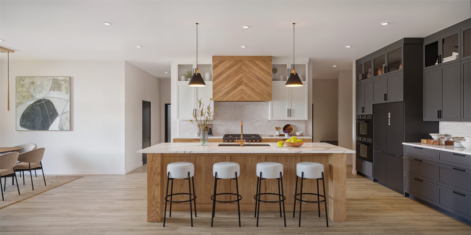 541 Arborland Drive Georgetown, TX 78633 - Photo 3 of 4 a kitchen with stainless steel appliances granite countertop a stove a sink a refrigerator and a dining table with wooden floor
