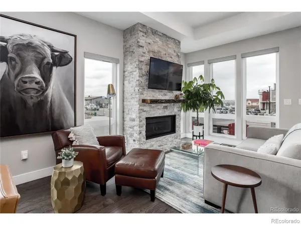 a living room with furniture a flat screen tv and a fireplace