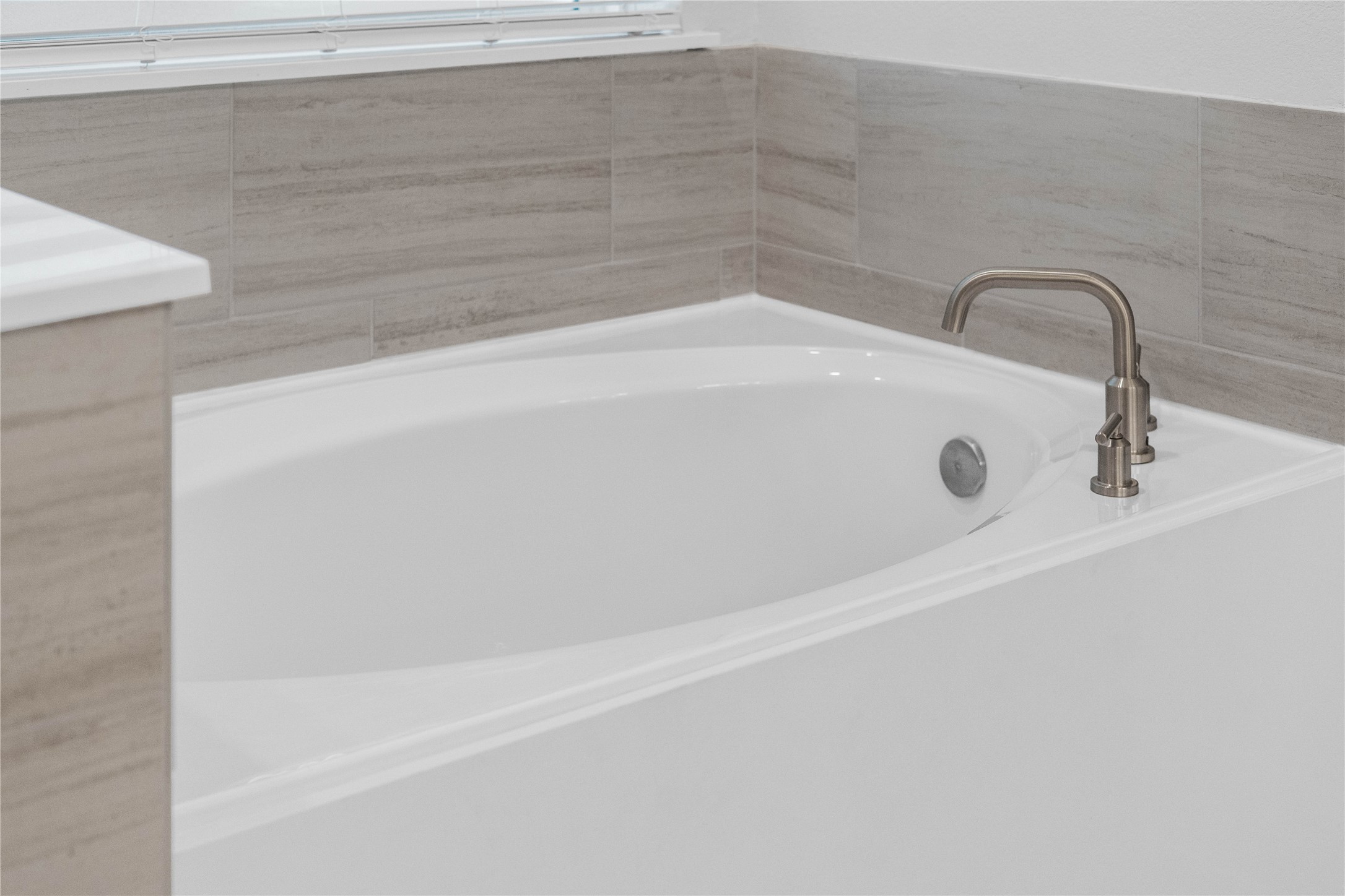 2035 Frst Strm Way Conroe, TX 77304 - Photo 32 of 45 Unwind after a long day in the deep, soaking tub, a perfect sanctuary for relaxation. The tub is accented by stylish, warm-toned fixtures.