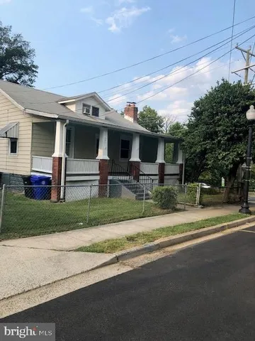 a front view of house with a garden and plants