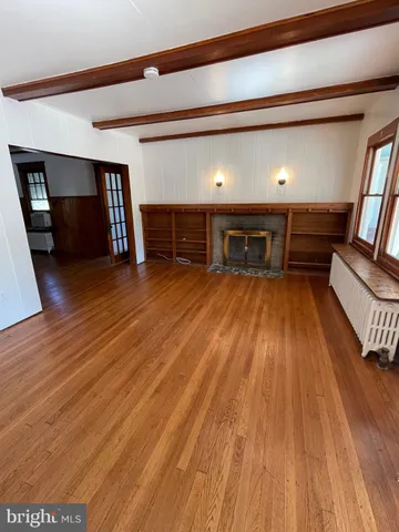 a room with wooden floor and furniture