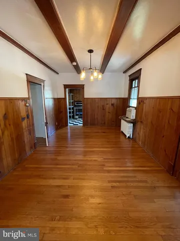 a view of a room with wooden floor