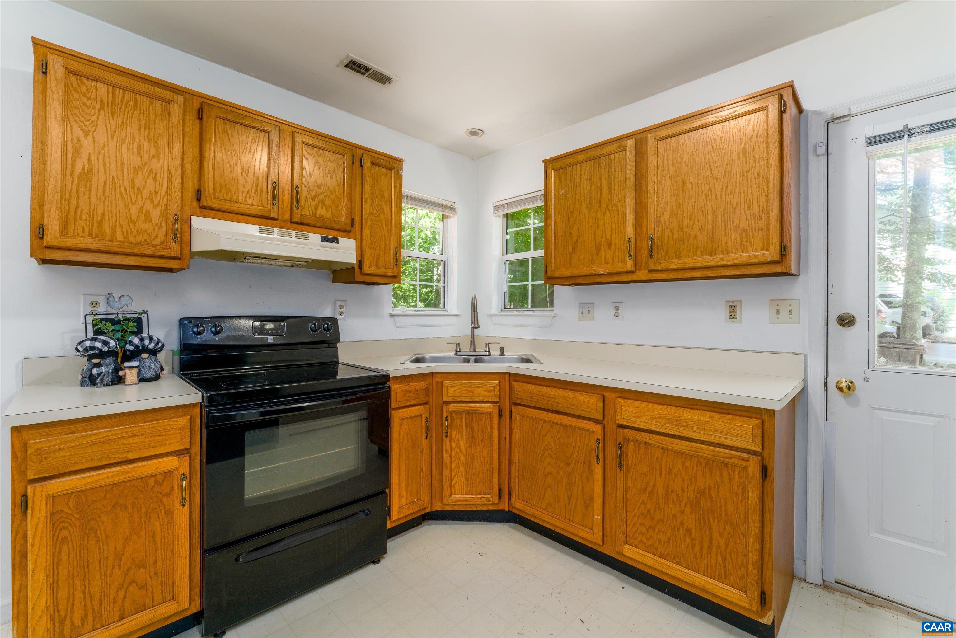 17 Riverside Drive Palmyra, VA 22963 - Photo 17 of 32 a kitchen with stainless steel appliances granite countertop wooden cabinets sink and a granite counter top