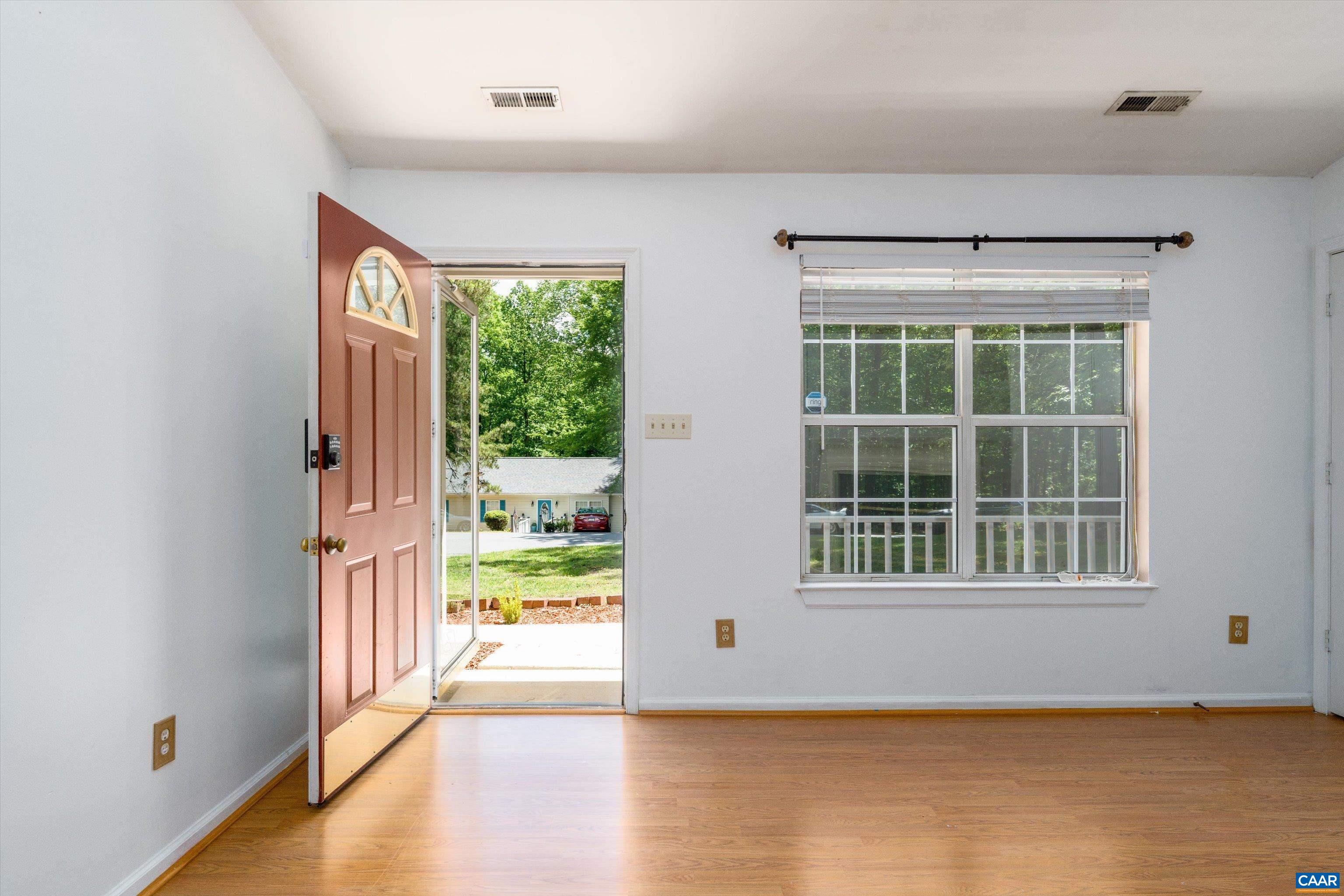 17 Riverside Drive Palmyra, VA 22963 - Photo 4 of 32 an empty room with wooden floor and windows