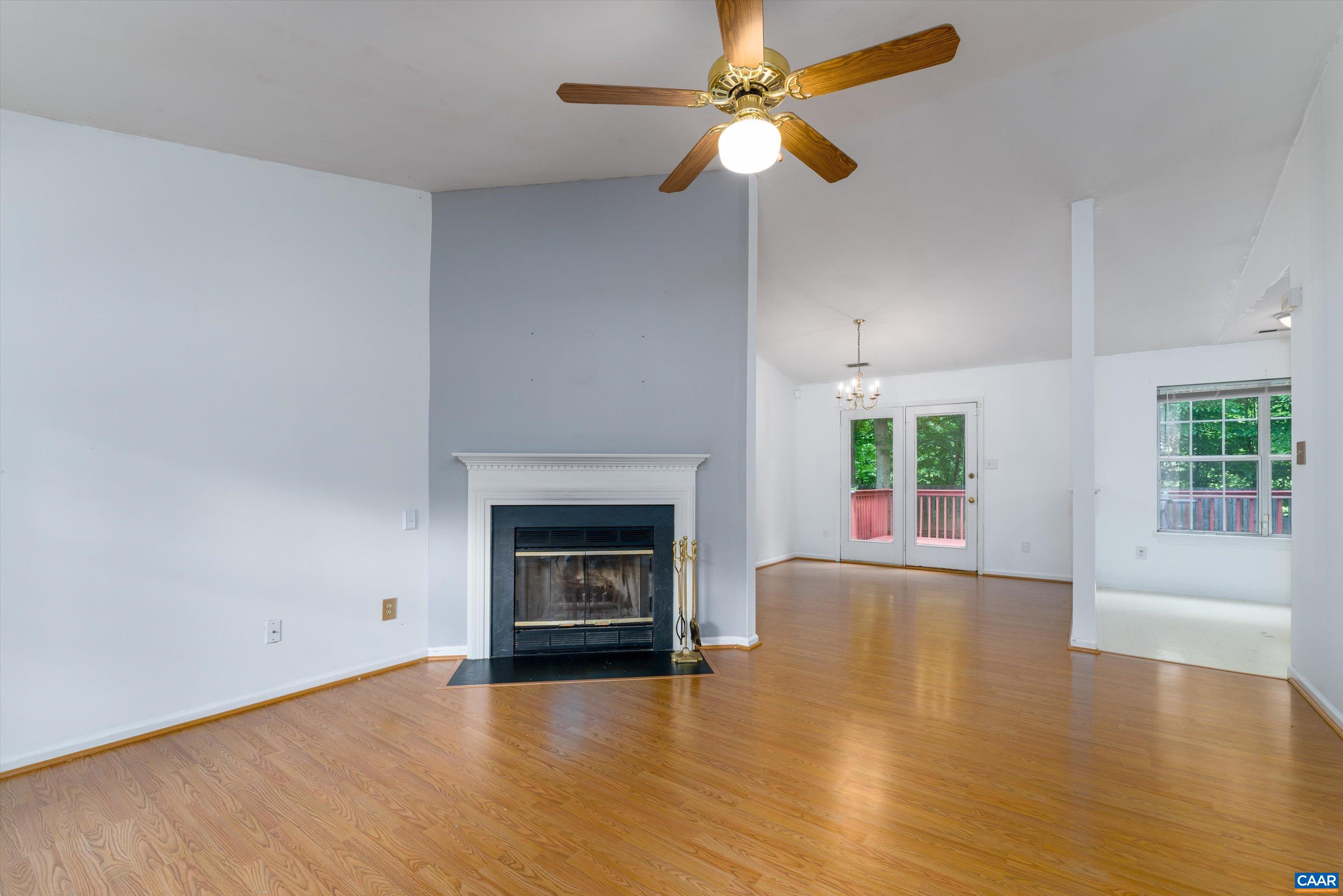 17 Riverside Drive Palmyra, VA 22963 - Photo 5 of 32 an empty room with windows fireplace and a ceiling fan