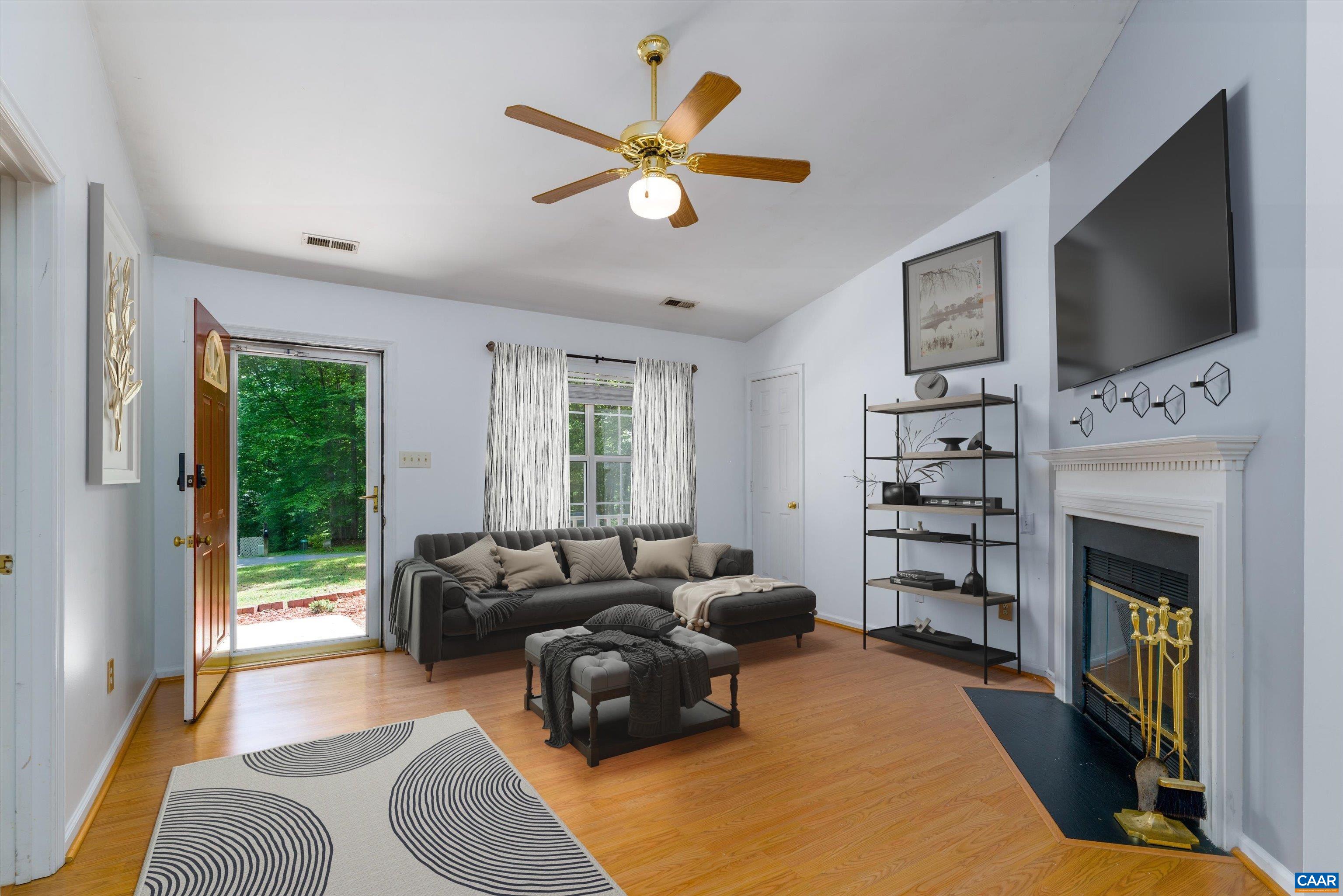 17 Riverside Drive Palmyra, VA 22963 - Photo 7 of 32 a living room with furniture a fireplace and a flat screen tv