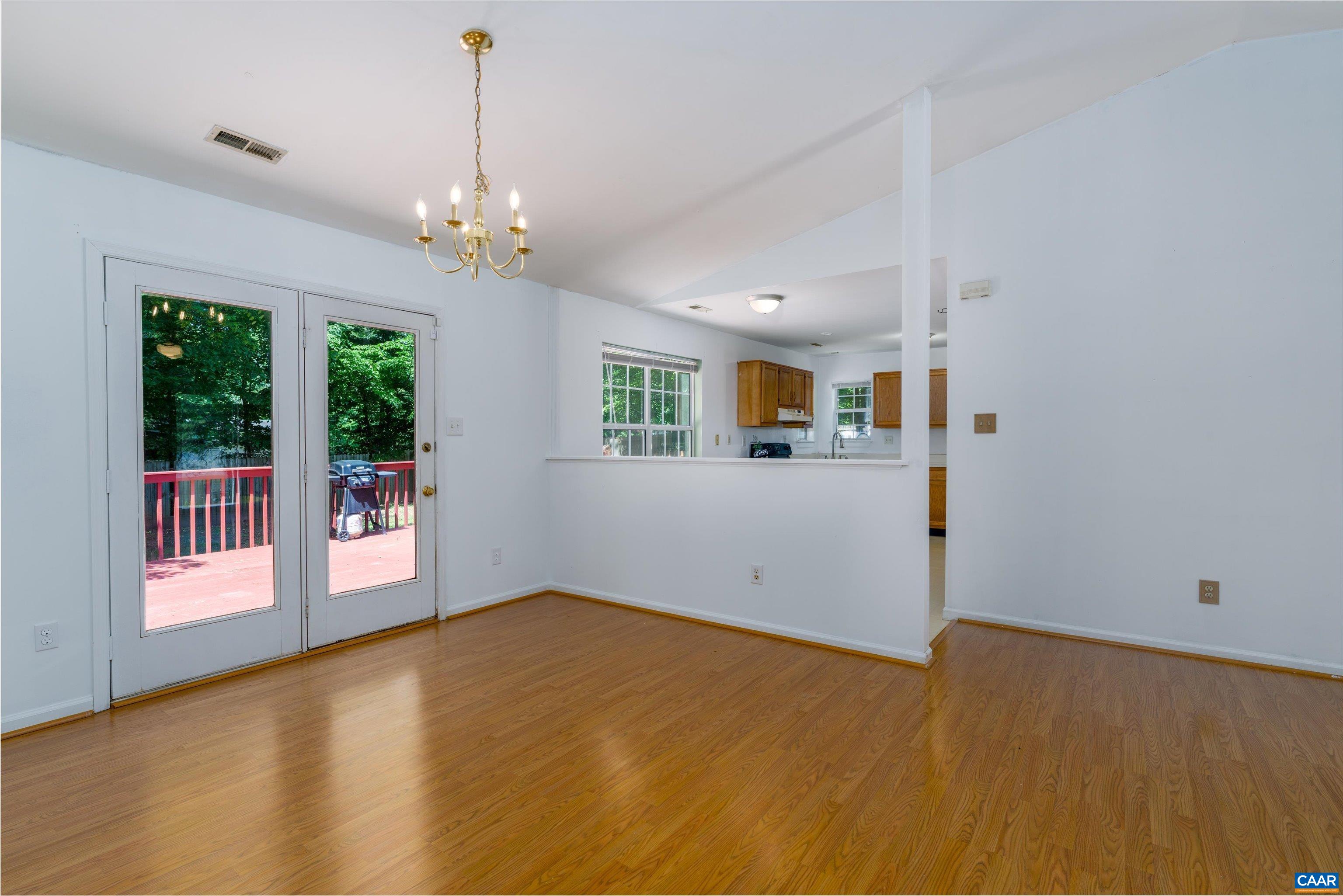 17 Riverside Drive Palmyra, VA 22963 - Photo 10 of 32 a view of a livingroom with a chandelier fan and windows