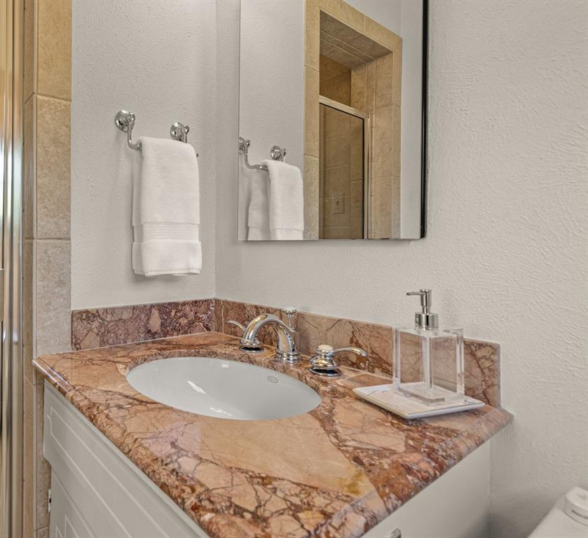 3628 Potomac Avenue Fort Worth, TX 76107 - Photo 25 of 32 a bathroom with a granite countertop sink and a mirror
