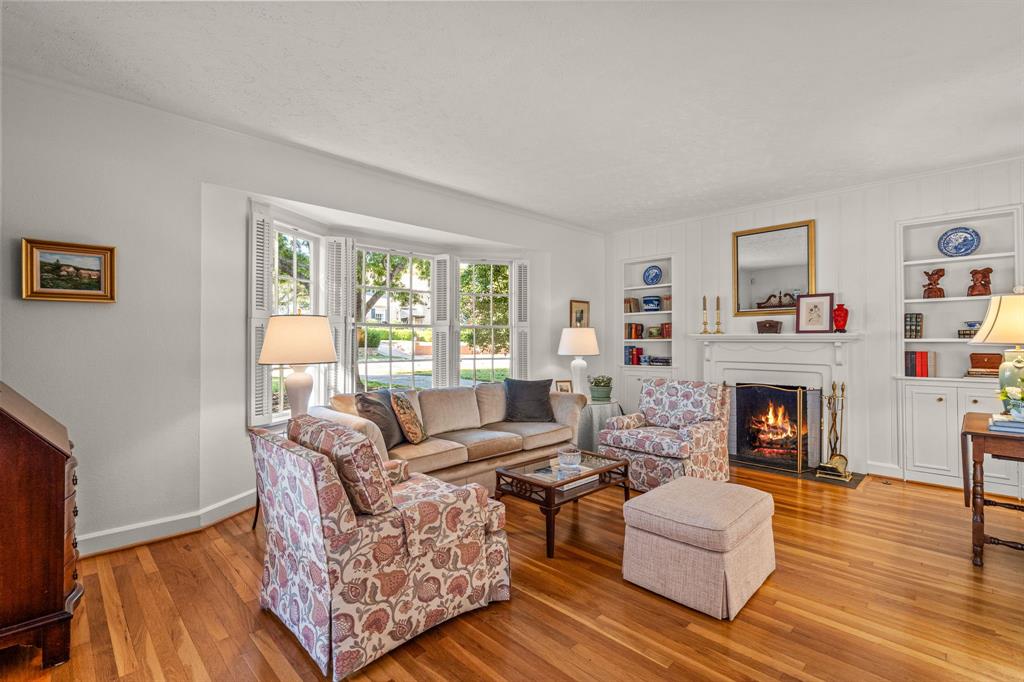 3628 Potomac Avenue Fort Worth, TX 76107 - Photo 10 of 32 a living room with furniture a fireplace and a wooden floor