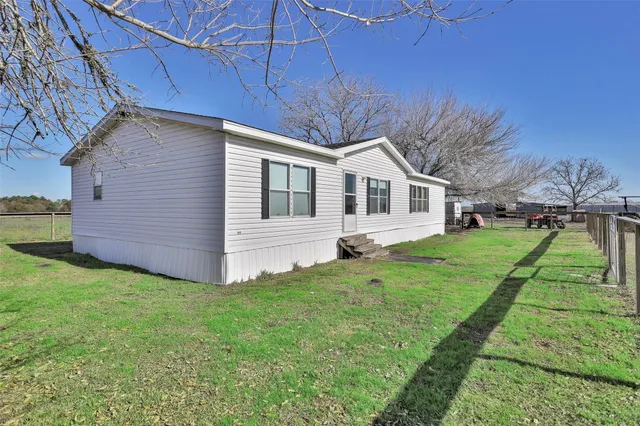 a backyard of a house with lots of green space