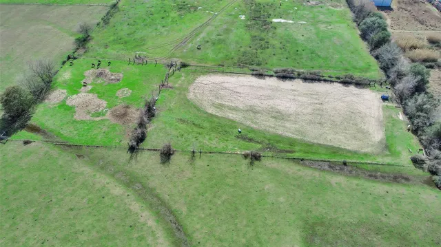 an aerial view of a house with a yard
