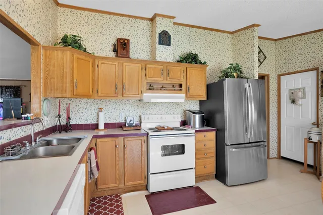a kitchen that has a lot of cabinets and refrigerator