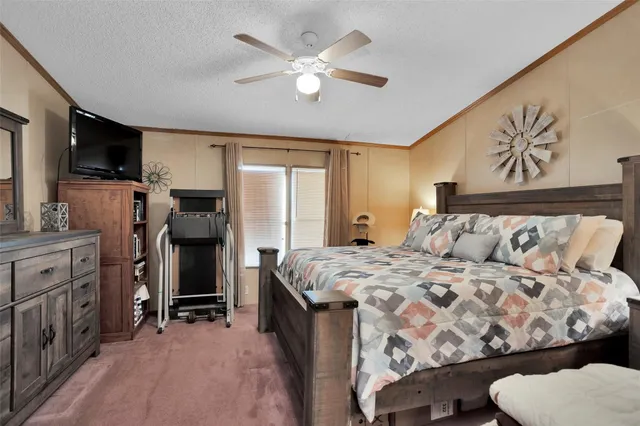 a bed sitting in a bedroom next to a window