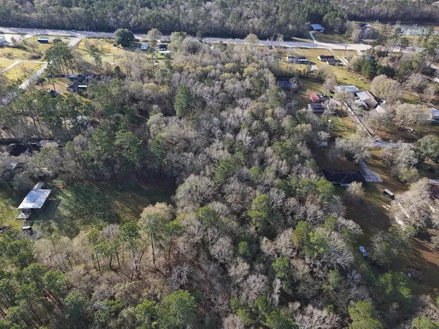a view of house with yard and outdoor seating