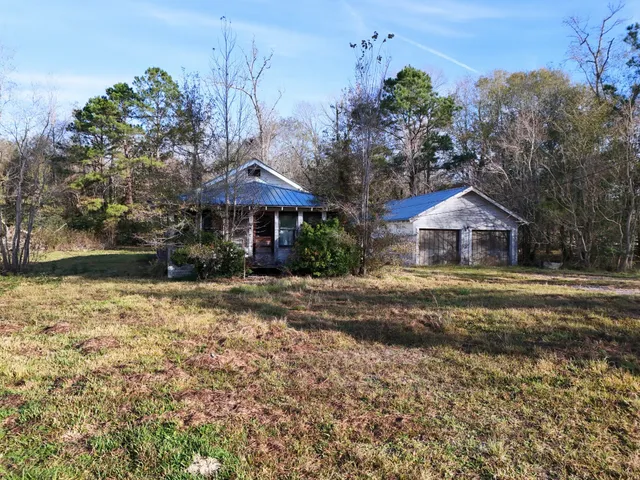 a view of a backyard with wooden fence