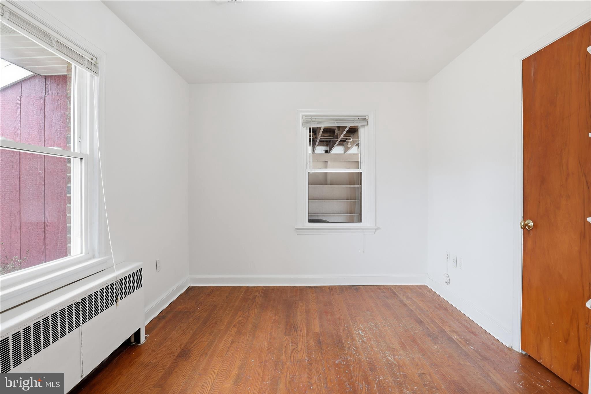 6003 Brookland Road Alexandria, VA 22310 - Photo 11 of 26 an empty room with wooden floor and windows