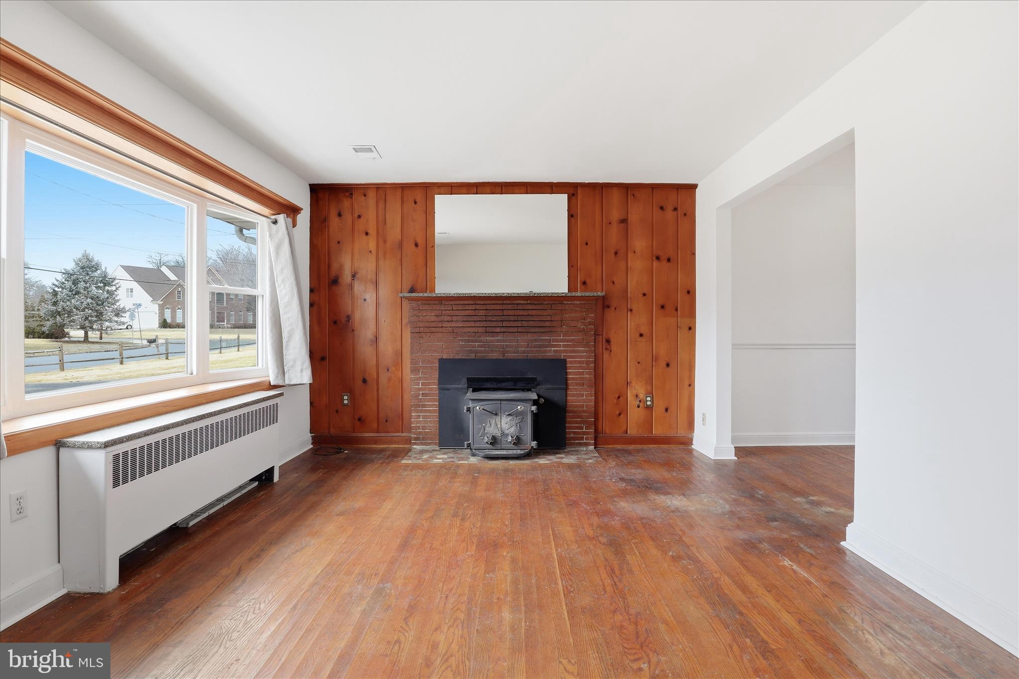 6003 Brookland Road Alexandria, VA 22310 - Photo 3 of 26 a view of an empty room with a window and a fireplace