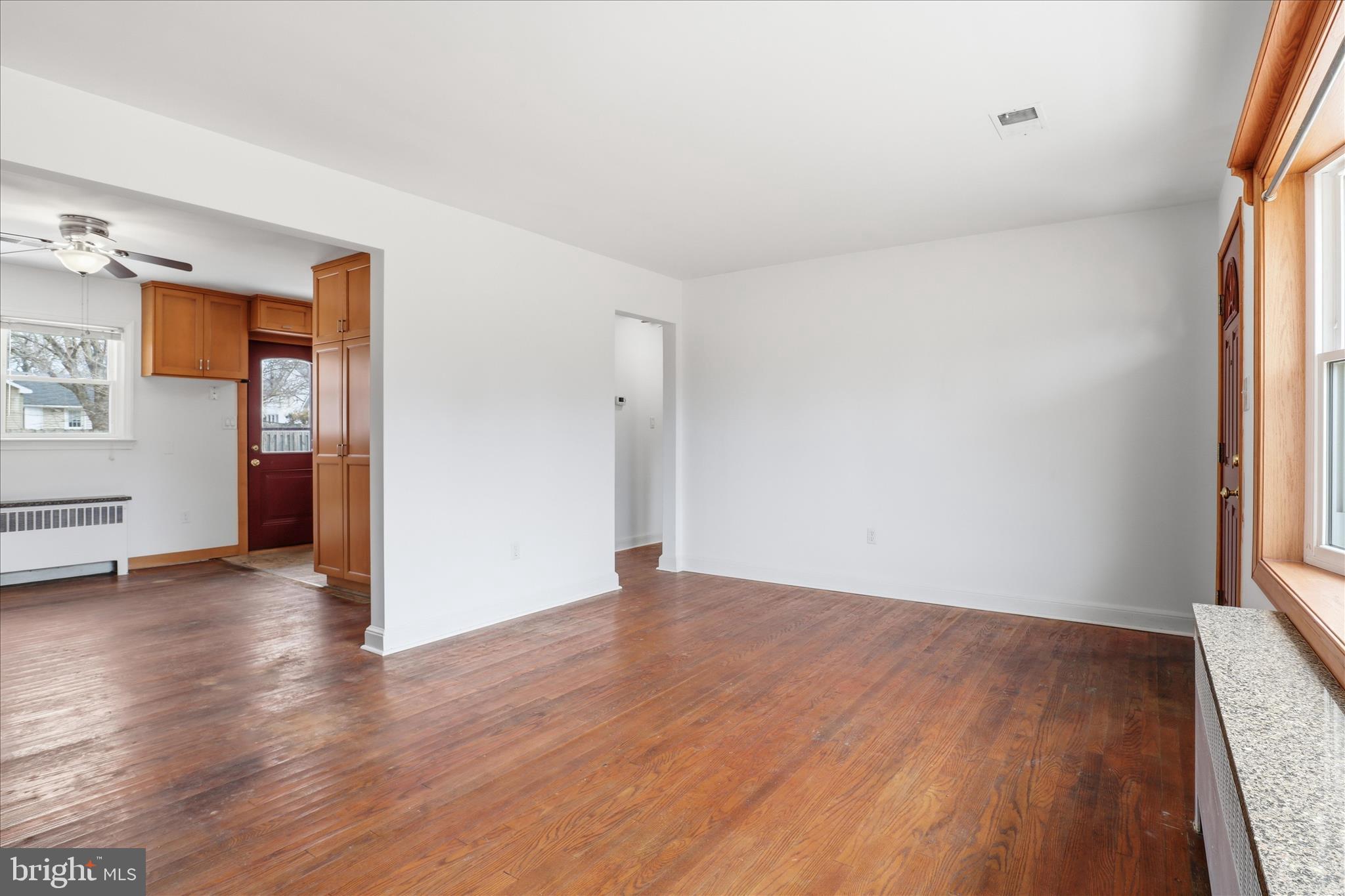 6003 Brookland Road Alexandria, VA 22310 - Photo 4 of 26 an empty room with wooden floor and windows