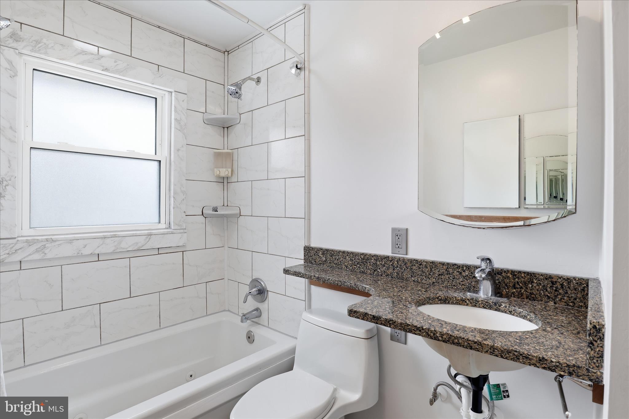 6003 Brookland Road Alexandria, VA 22310 - Photo 10 of 26 a bathroom with a granite countertop sink toilet and shower