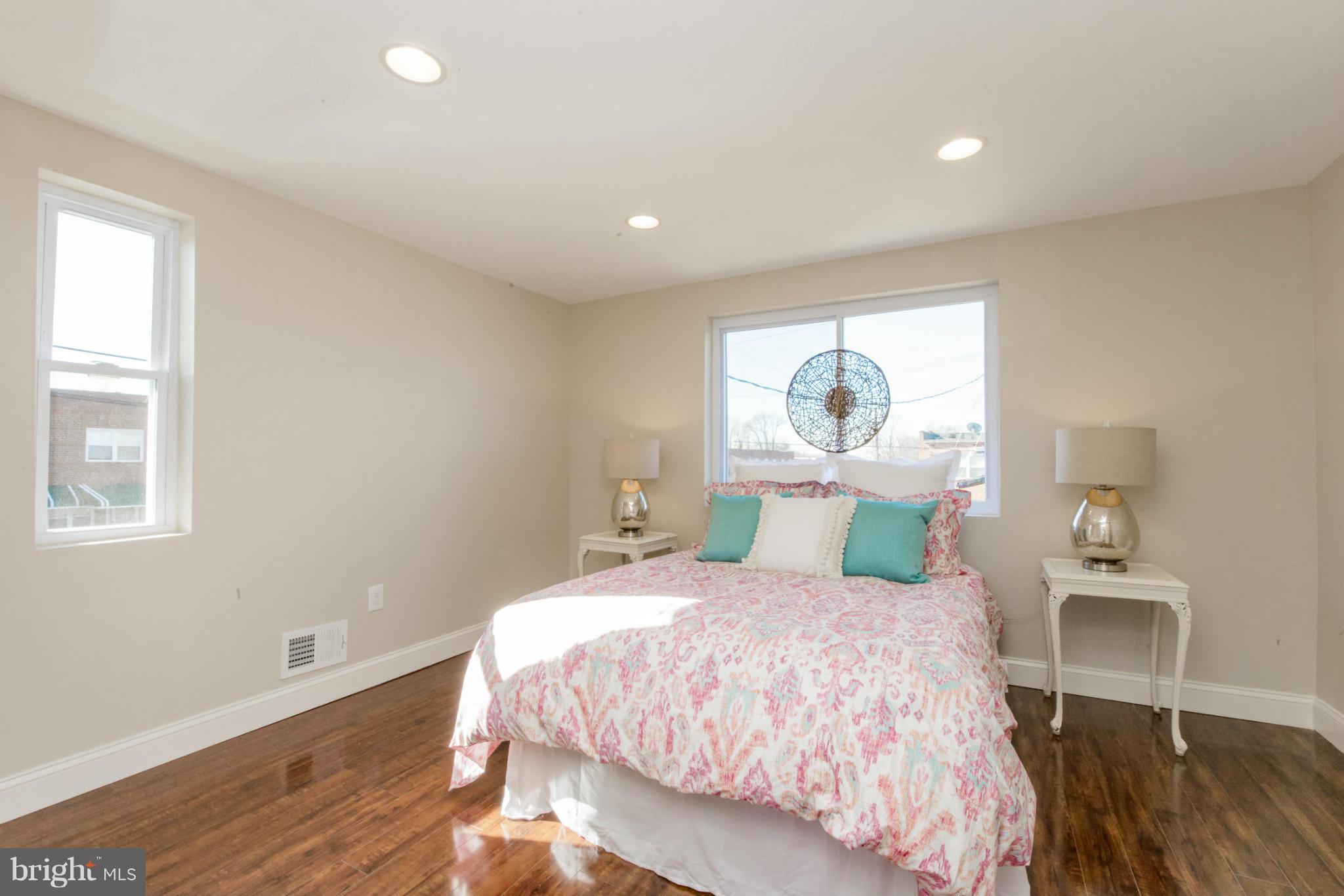 6922 Reisterstown Road Baltimore, MD 21215 - Photo 13 of 30 a bedroom with a bed table and window