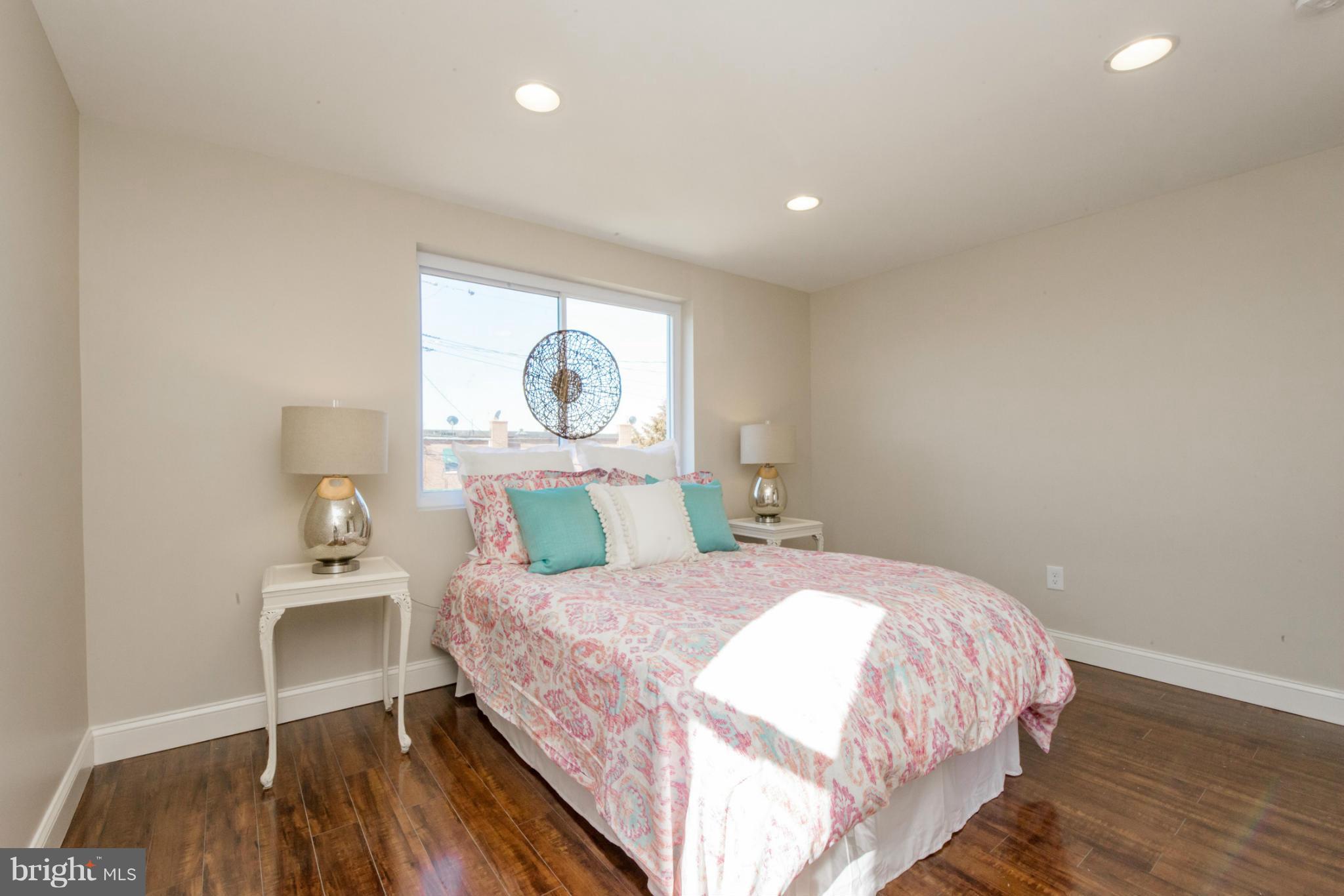 6922 Reisterstown Road Baltimore, MD 21215 - Photo 14 of 30 a bedroom with a bed and a painting on the wall