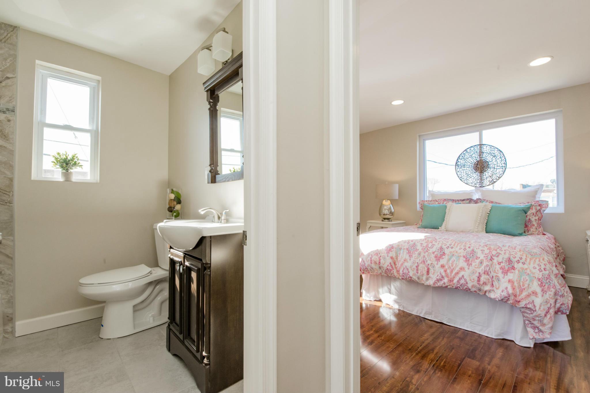 6922 Reisterstown Road Baltimore, MD 21215 - Photo 15 of 30 a bedroom with a bed and a bathroom