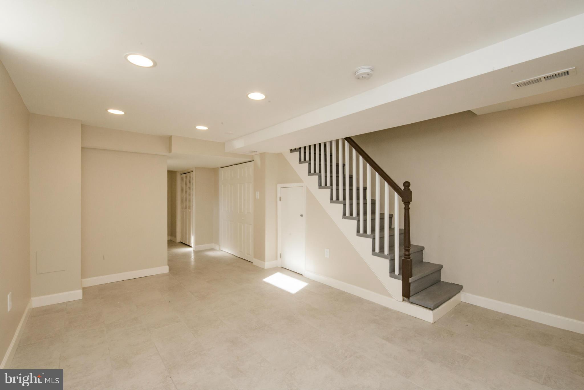 6922 Reisterstown Road Baltimore, MD 21215 - Photo 22 of 30 a view of an empty room with stairs