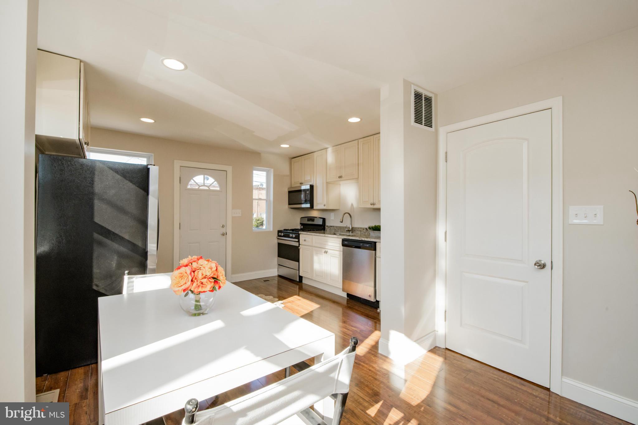6922 Reisterstown Road Baltimore, MD 21215 - Photo 6 of 30 a kitchen with stainless steel appliances kitchen island granite countertop a refrigerator and a sink