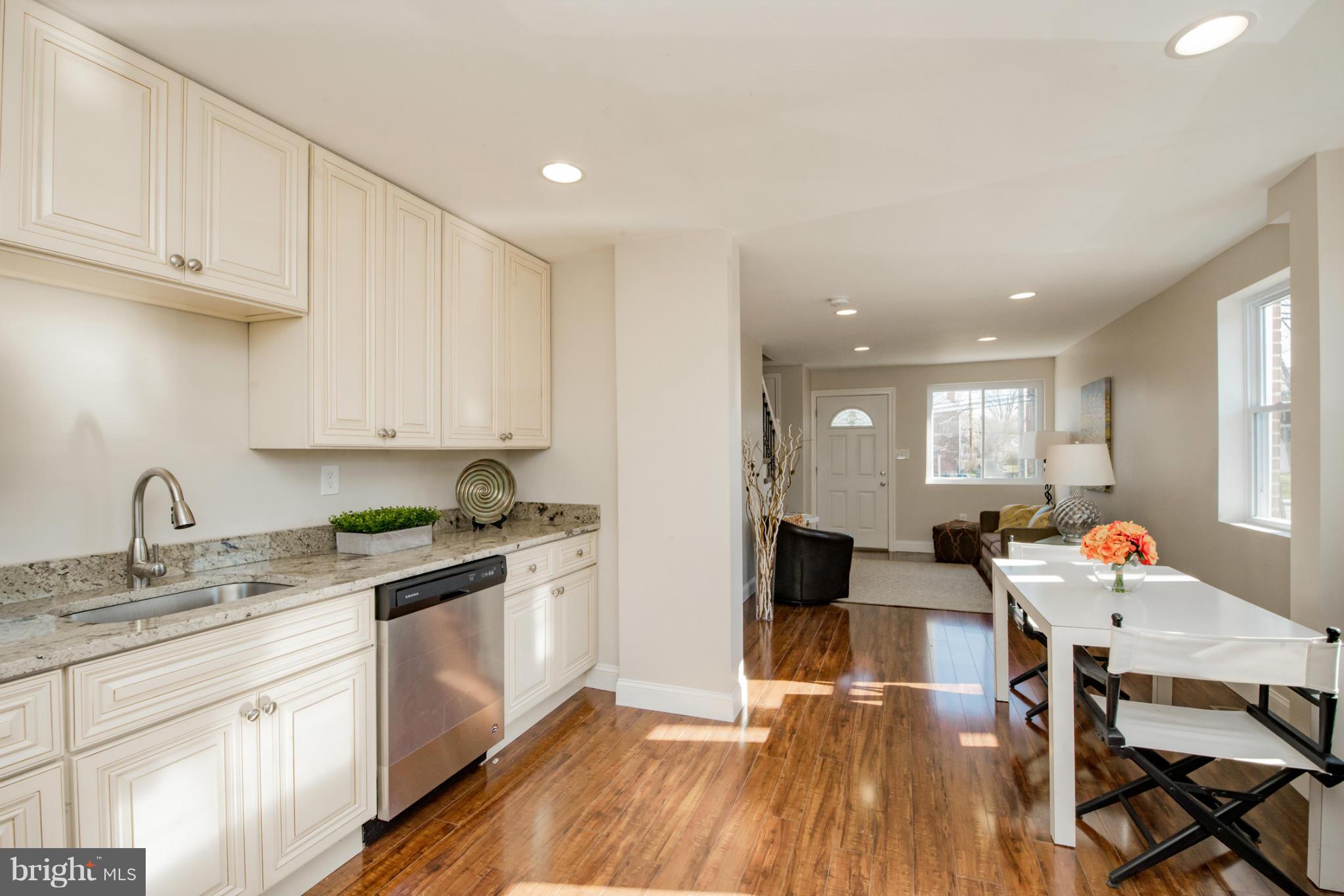 6922 Reisterstown Road Baltimore, MD 21215 - Photo 10 of 30 a open kitchen with sink cabinets and wooden floor