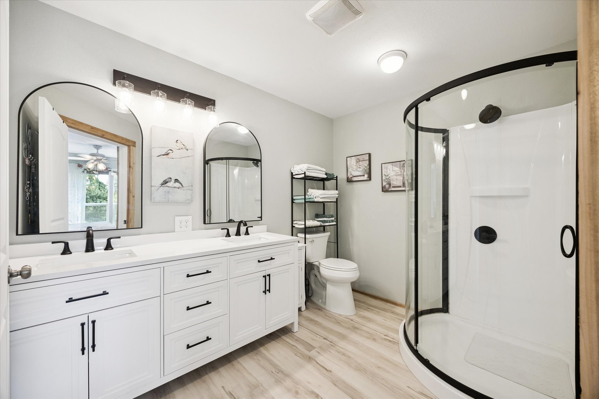 9015 Highway 36 Brenham, TX 77833 - Photo 14 of 19 a bathroom with a double vanity sink toilet mirror and shower